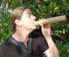 Unidentified woman enjoying a tootle-e-toot when she probably oughta be working.